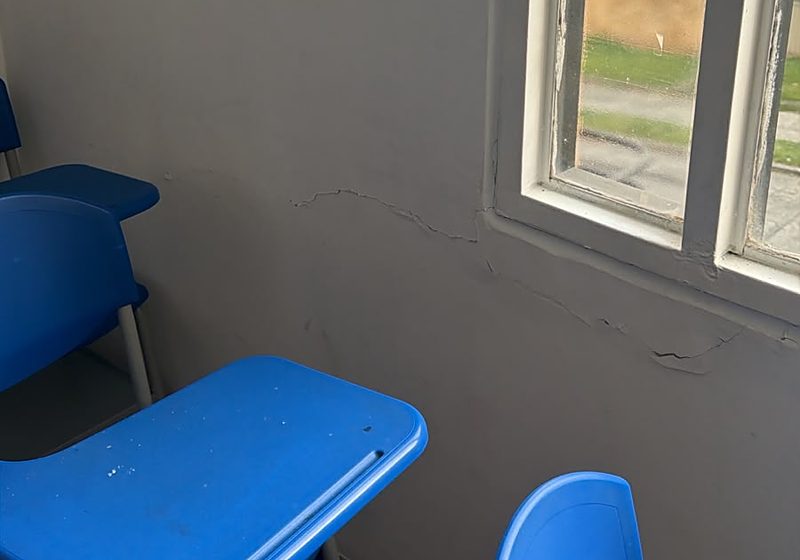 Aula del Colegio INTEC en Armenia con pupitres azules y fisura bajo la ventana tras el sismo de 2026